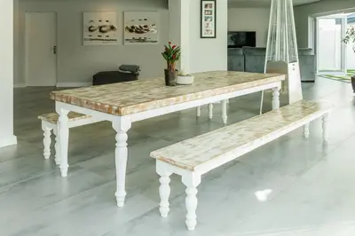 a table and a bench in a living room at Beach House in Sunset Beach in Cape Town