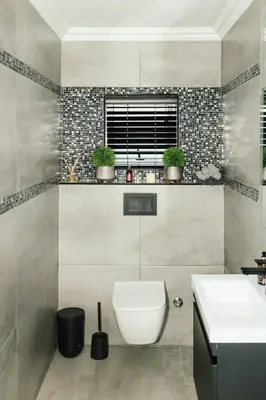 a bathroom with a toilet and a sink at Beach House in Sunset Beach in Cape Town