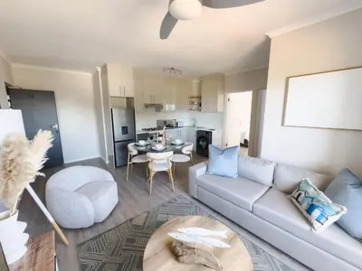 a living room with a couch and a table at Manchester Heights Deluxe Apartments in Cape Town