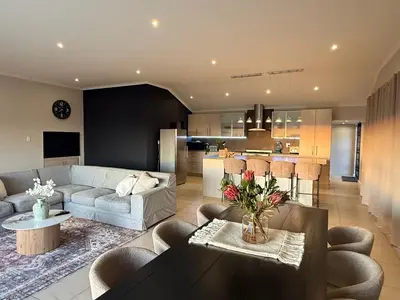 a living room with a couch and a table at Luxe Stay Somerset West 4 in Somerset West