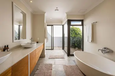 a bathroom with two sinks and a tub at Winelands Luxury Accommodation in Stellenbosch