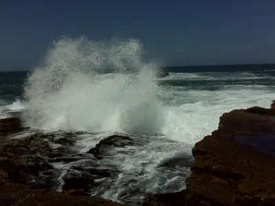a wave crashing on the shore of the ocean at Milkwood Lodge in Hermanus
