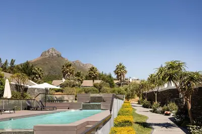 a pool at a resort with a mountain in the background at Winelands Luxury Unit in Stellenbosch