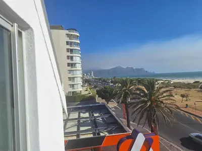 a view of the beach from a balcony of a building at Salted in Cape Town