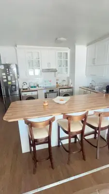 a kitchen with a large wooden table and chairs at Luxury Beach Front Apartment in Strand