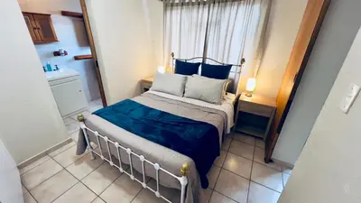 a small bedroom with a bed and a window at Casa Kari in Brackenfell