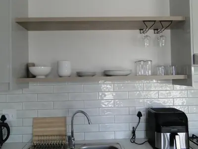 a kitchen with a sink and a counter with dishes at Fresh Air in Cape Town