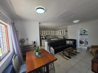 a living room with a couch and a table at Alvera in Strand