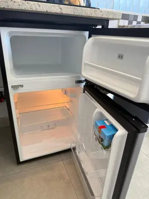 an open refrigerator with its door open and a drawer at Welcome Home in Somerset West