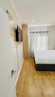 a bedroom with a bed and a television in it at Your Perfect Little Cozy Getaway in Cape Town