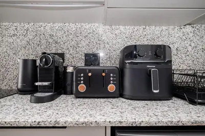 a group of appliances sitting on top of a counter at 113 Paarl 2 Bedroom Lux Aprt With Parking & Aircon in Paarl