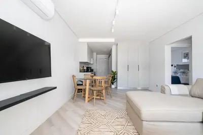 a living room with a couch and a flat screen tv at 113 Paarl 2 Bedroom Lux Aprt With Parking & Aircon in Paarl