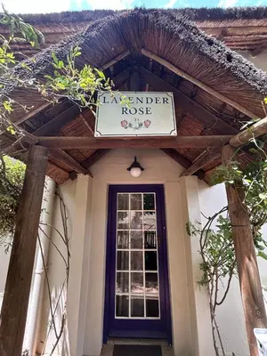 a house with a sign on the front of it at The Little Thatch Cottage in Greyton