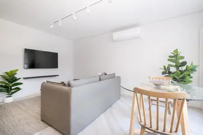 a living room with a couch and a table at 116 Paarl - Lux 1 Bedroom Apt with AC and Parking in Paarl