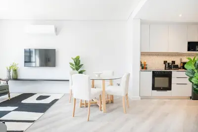a kitchen and dining room with a table and chairs at 213 Paarl 2 Bedroom Lux Aprt With Parking & Aircon in Paarl