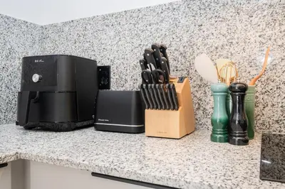 a counter top with a knife block and a kitchen counter top at 216 Paarl Lux 1 Bdrm Apt with Parking and AC in Paarl