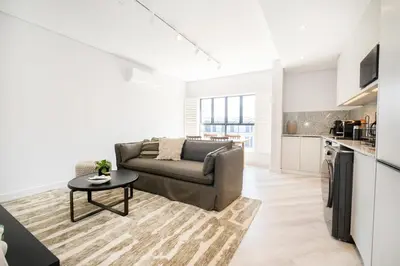 a living room with a couch and a table at 216 Paarl Lux 1 Bdrm Apt with Parking and AC in Paarl