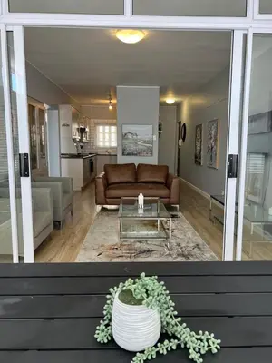 a living room with a couch and a table at Strandsig 308, 96 beach road in Strand