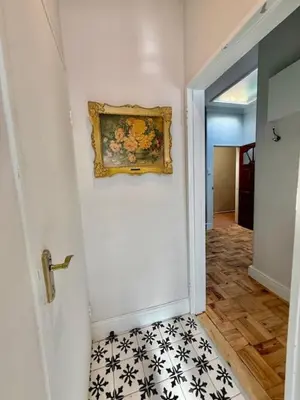 a hallway with a painting on the wall and a door at 26 at Blumenhof in Stellenbosch