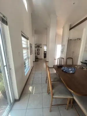 a dining room with a wooden table and chairs at 22 on BREEZAND in Cape Town