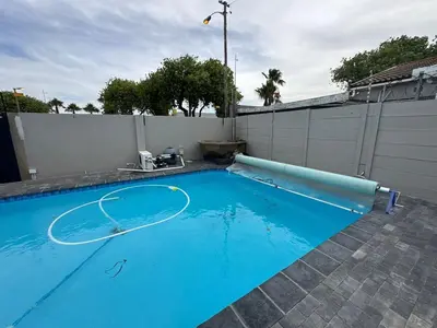 a blue swimming pool with a basketball hoop in it at Lansdowne Lodge in Welton