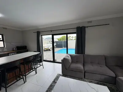 a living room with a couch and a table and a kitchen at Lansdowne Lodge in Welton