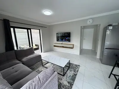a living room with a couch and a tv at Lansdowne Lodge in Welton