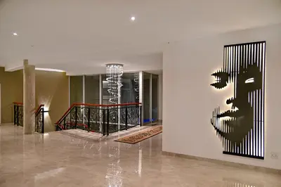 a painting of a face on a wall in a building at The Coach House at Val du Charron in Wellington