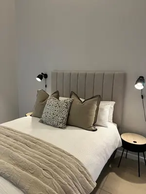 a bedroom with a large bed with pillows at Little Nest in Somerset West