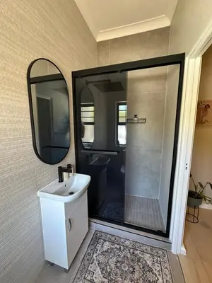 a bathroom with a sink and a mirror at Little Nest in Somerset West