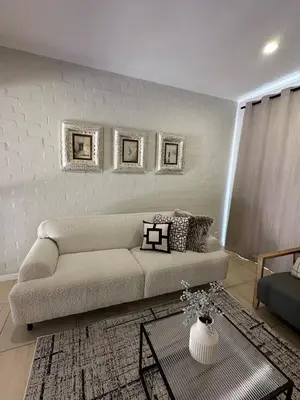 a living room with a couch and a table at Little Nest in Somerset West
