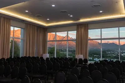 a conference room with chairs and windows with mountains at Protea Hotel by Marriott Stellenbosch & Conference Centre in Stellenbosch