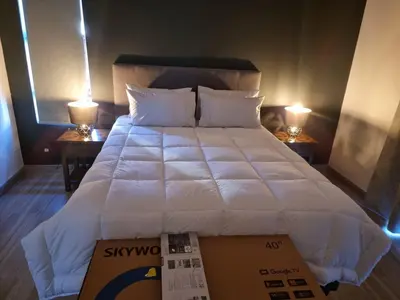 a bedroom with a large white bed with two lamps at Milino Guest House in Cape Town