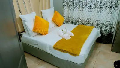 a bedroom with a bed with towels on it at DC Guest House in Avondale