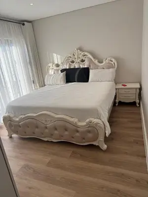 a bedroom with a white bed with a white headboard at Durbanville apartment in Durbanville