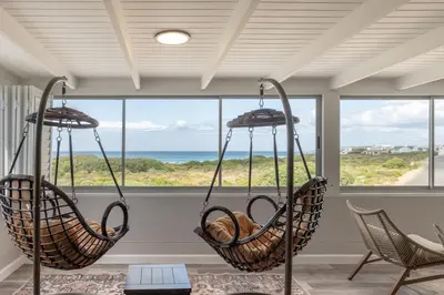 two hanging baskets in a room with a view of the ocean at Coats Haven in Hermanus
