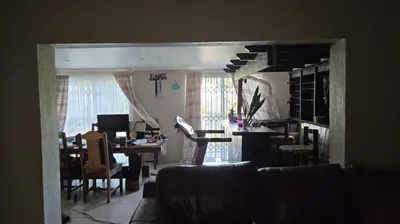 a living room with a couch and a dining room at Nyati in Cape Town