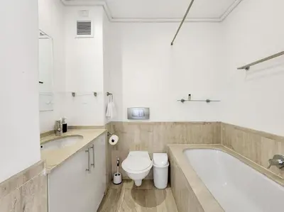 a bathroom with a tub and a toilet and a sink at Seaside Serenity with Ocean View in Cape Town