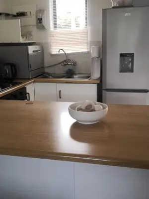 a bowl on a wooden counter in a kitchen at Duplex in Tableview in Cape Town