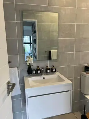 a bathroom with a white sink and a mirror at The Jade, Somerset West in Strand