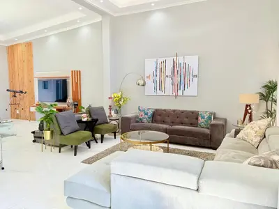 a living room with a couch and a table at Centrally located 11 sleeper house near Canal Walk in Cape Town