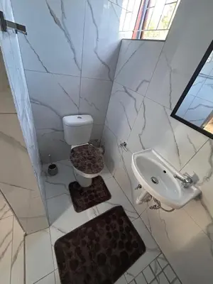 a bathroom with a toilet and a sink at New Dawn Guest House in Goodwood