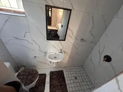 a bathroom with a sink and a mirror at New Dawn Guest House in Goodwood