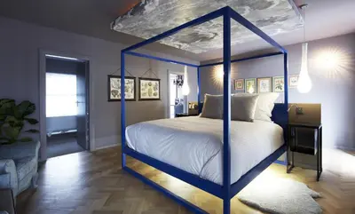 a bed with a blue canopy bed in a room at Majeka House Boutique Hotel by The Living Journey Collection in Stellenbosch