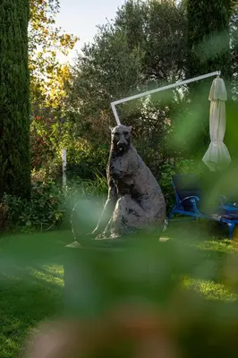 a statue of a bear sitting in a yard at Majeka House Boutique Hotel by The Living Journey Collection in Stellenbosch