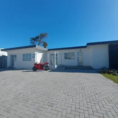 a motorcycle parked in front of a house at Nemesia Suites in Cape Town