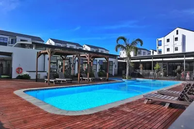 a swimming pool in front of a building at 1 table mountain view in Cape Town
