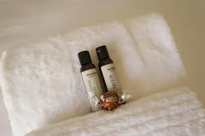 two bottles of moisturizers sitting on a white towel at Story Haus in Stellenbosch
