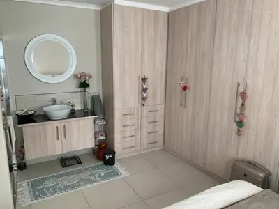 a bathroom with a sink and a mirror at Entire large 1 bedroom very private with parking in Cape Town