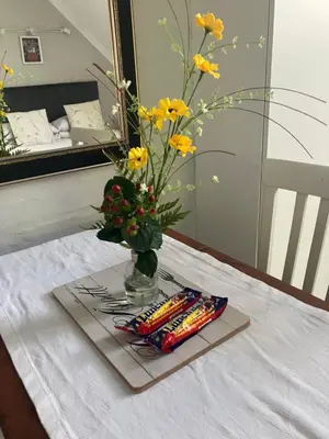 a vase with flowers and crayons on a table at Starry Starry Night Loft, with Aircon in Die Boord in Stellenbosch